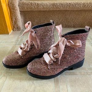 Pink glitter combat boots with ribbon ties.